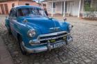 Cuba, Trinidad Blue Taxi Parked On Cobblestones