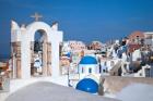 Bell tower and blue domes of church in village of Oia, Santorini, Greece