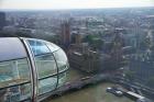 London Eye as it passes Parliament and Big Ben, Thames River, London, England