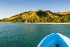 Blue boat cruising through the Yasawa, Fiji, South Pacific