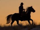 Cowboy Riding His Horse Winters Snow Silhouetted At Sunset