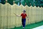 1980s Smiling Boy Running Along Sidewalk