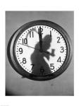 Close-up of the shadow of a person carrying a scythe on a clock