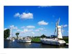 Boats moored near a traditional windmill, River Thurne, Norfolk Broads, Norfolk, England
