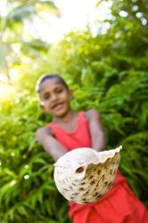 Village boy with large sea shell, Beqa Island, Fiji | Obraz na stenu