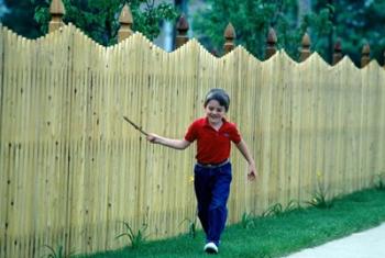 1980s Smiling Boy Running Along Sidewalk | Obraz na stenu