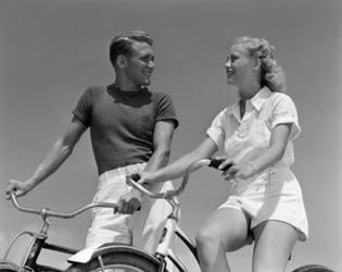 1930s 1940s Smiling Couple On Bikes Looking At One Another | Obraz na stenu