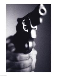 Close-up of a person holding a handgun | Obraz na stenu