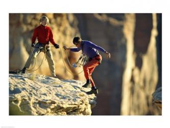 Two hikers with ropes at the edge of a cliff | Obraz na stenu