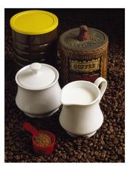 Close-up of a mug of milk with a measuring spoon and jars on coffee beans | Obraz na stenu