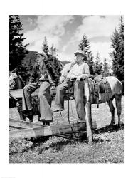 Teenage cowboys sitting on rail fence | Obraz na stenu