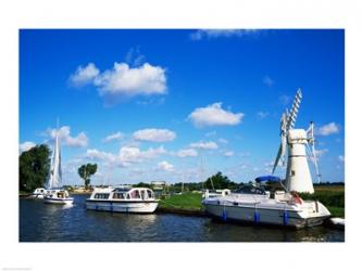 Boats moored near a traditional windmill, River Thurne, Norfolk Broads, Norfolk, England | Obraz na stenu